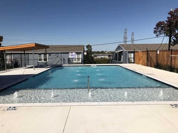 Commercial pool surrounded by cabins