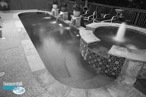 black and white photo of a oval shaped pool