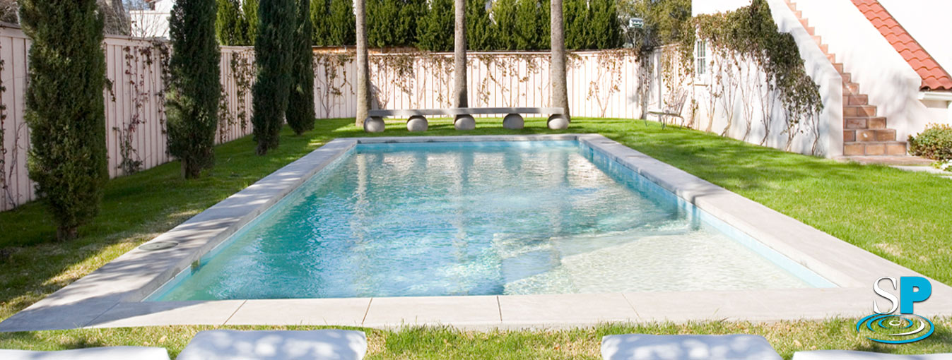 rectangle pool surrounded by trees