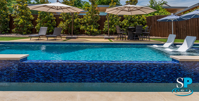 bright blue tile around a spa connected to a pool
