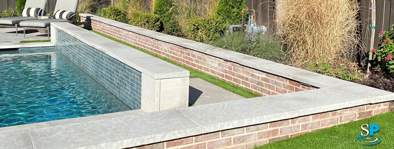 stone and brick raises walls around a pool