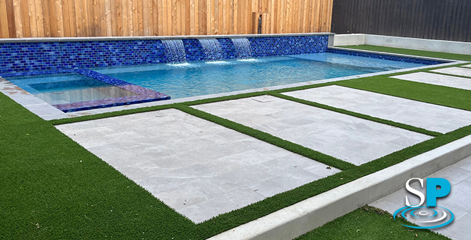 rectangular pool with bright blue pool tiles
