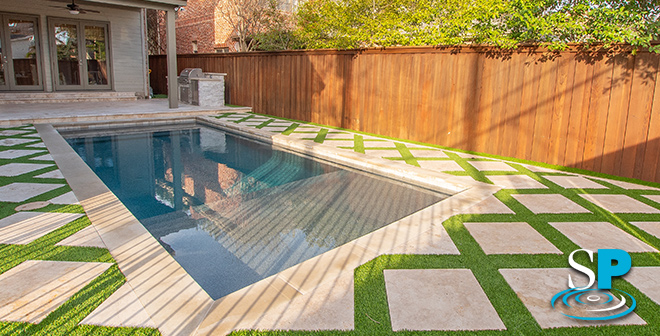 rectangular pool with geometric paver decking