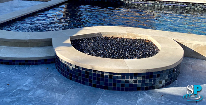 a firepit connected to a pool