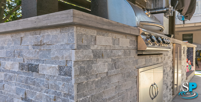 up close on the details of a outdoor kitchen made of stone