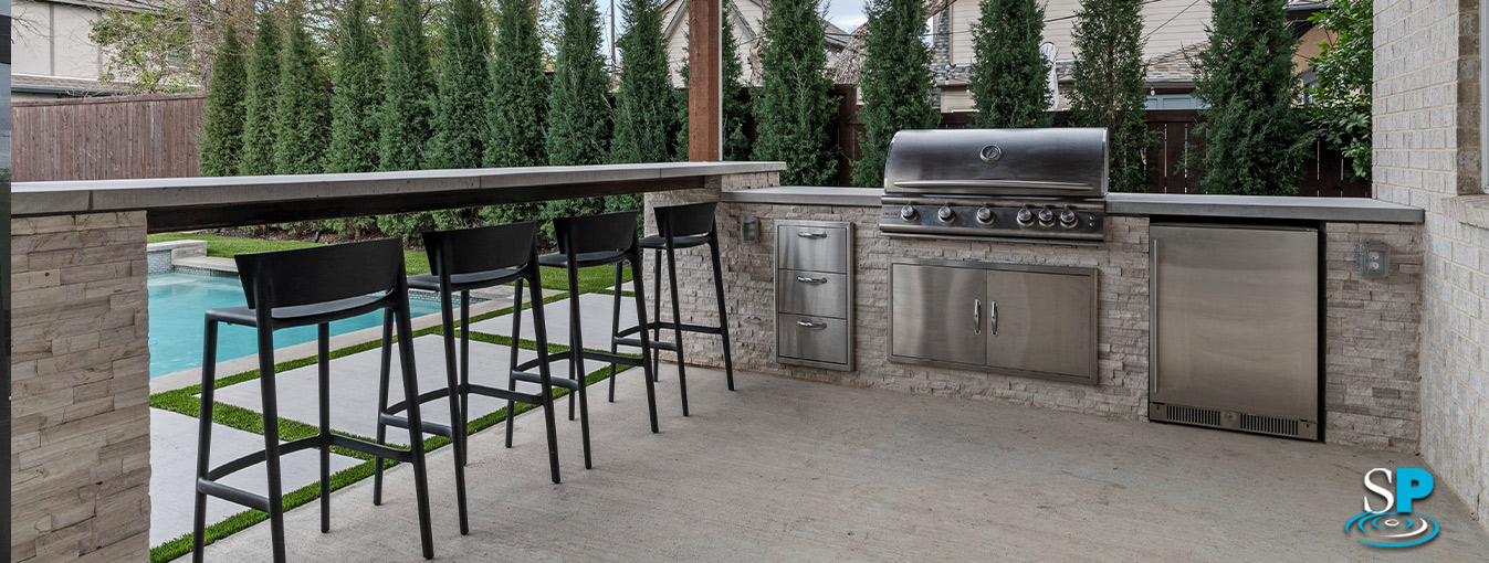 outdoor kitchen and bar seating area