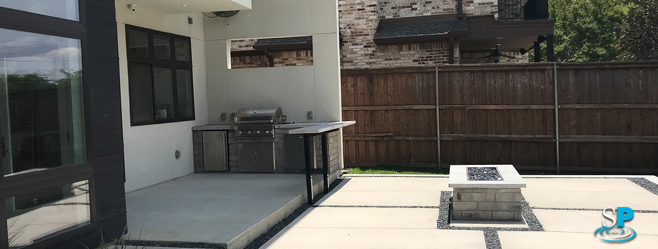 outdoor kitchen area and custom built fire pit