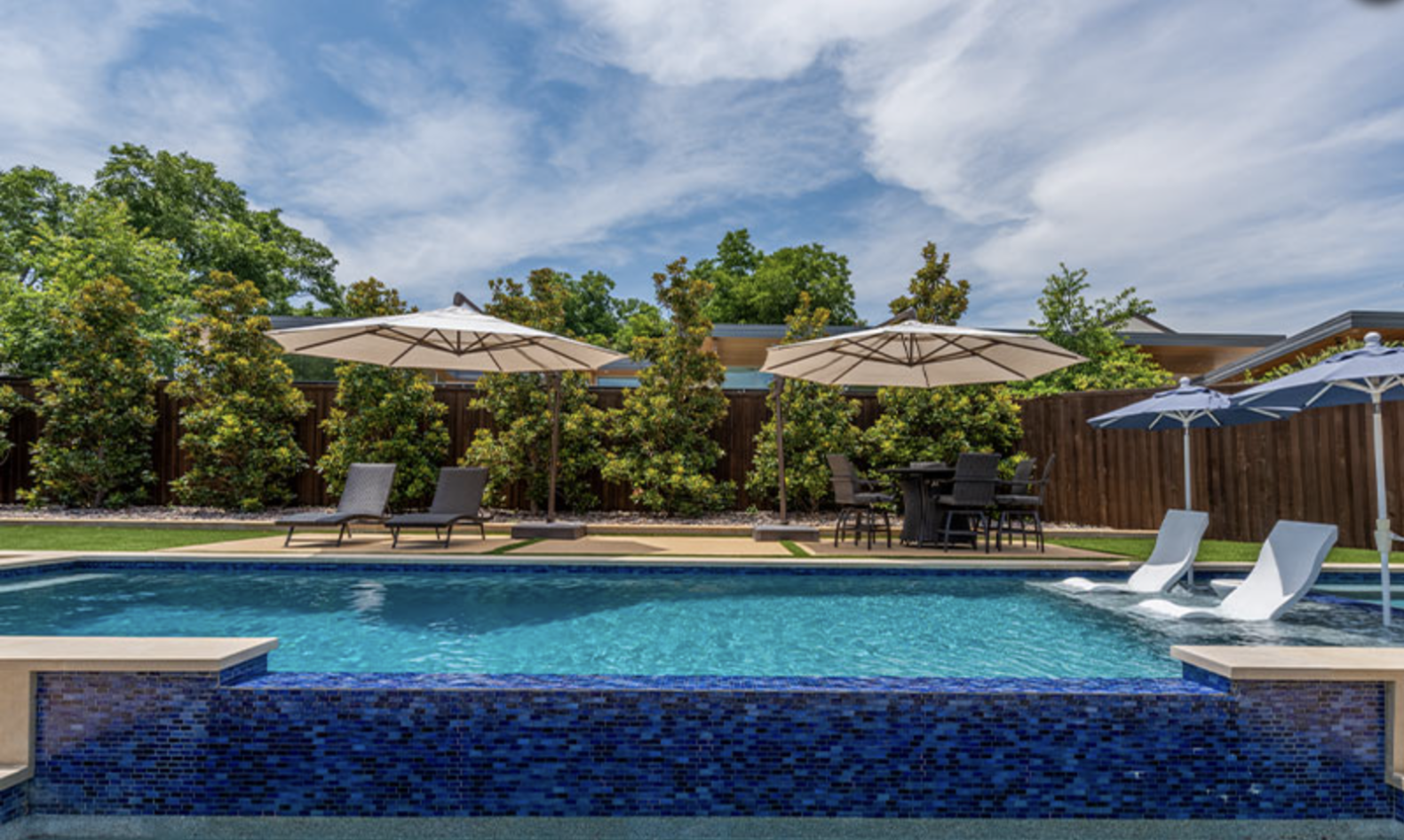 Swimming Pool in a dallas home backyard with pool features