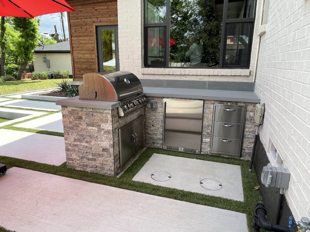 Summerhill Outdoor Living kitchen installation with premium grill, stone base, and modern patio design for residential backyard spaces