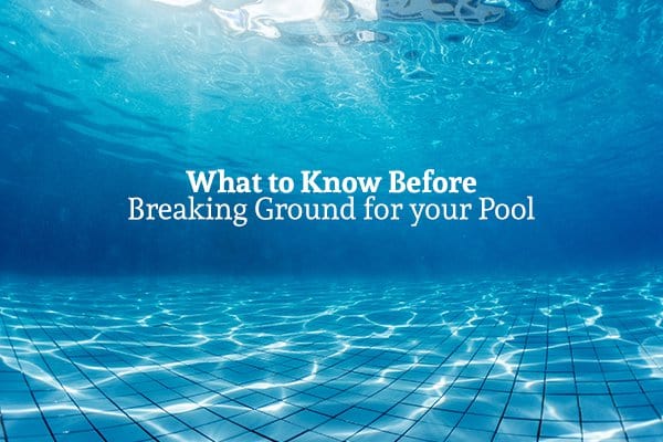 A view from underwater in a pool with the words "What to Know Before Breaking Ground for your Pool"